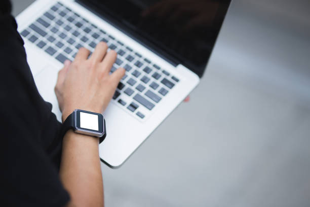 istock Man holding laptop and wear smartwatch 915637218