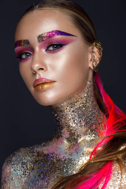 Beautiful girl with creative glitter makeup, sparkles, unusual eyebrows. Beauty is an art face. Beautiful girl with creative glitter makeup with sparkles, unusual eyebrows. Beauty is an art face. Photo taken in the studio. crazy makeup stock pictures, royalty-free photos & images