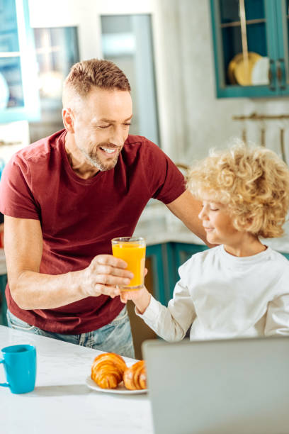 istock Joyful positive man holding a glass with juice 915637834