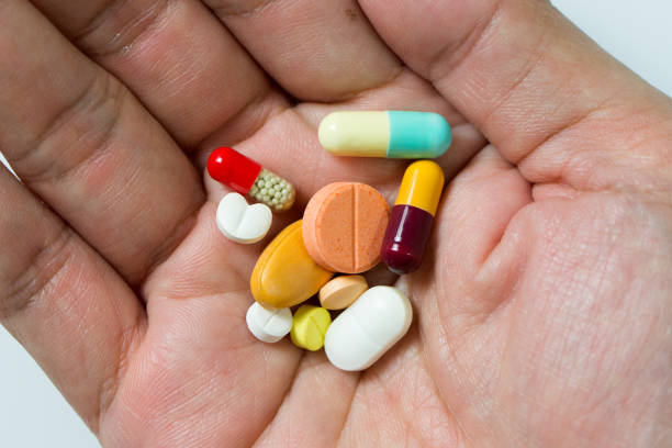istock Hand full of pills 915640208