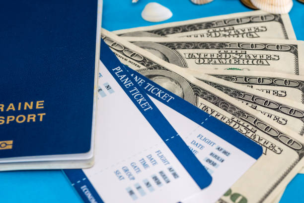 istock ticket with passport and dolls bills on blue 915640374