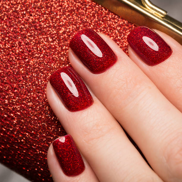 istock Bright festive red manicure on female hands. Nails design 915640434