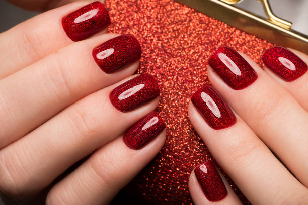 istock Bright festive red manicure on female hands. Nails design 915640460