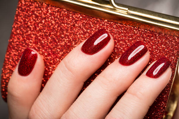 istock Bright festive red manicure on female hands. Nails design 915640476