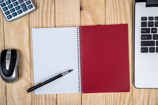 istock office desk with laptop, notepad, pen and calculator 915645350