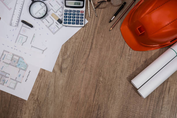 istock Construction concept - architectural project, blueprints, helmet, measuring tape 915648244