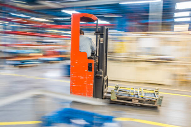 Forklift driving around in a factory.