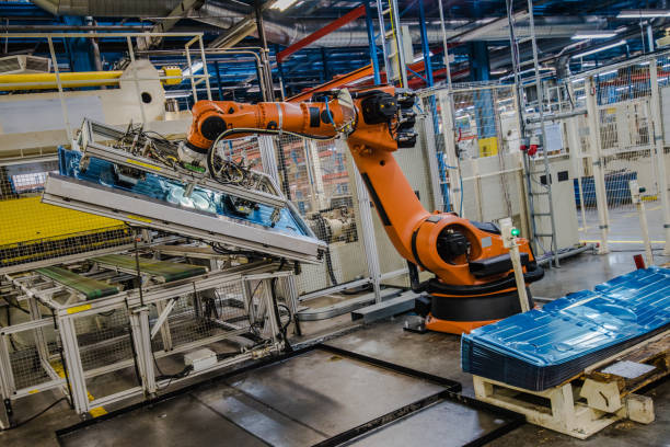 istock Industrial robot moving molded aluminium plate 915648464