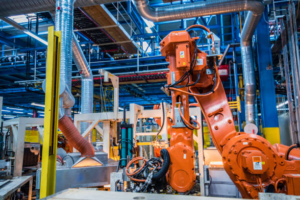 istock Industrial robotic arms performing operations 915648482