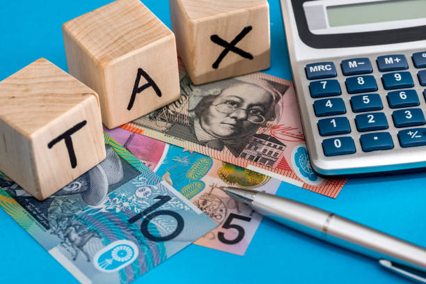 istock text tax with Australian dollar, pen and calculator 915651904