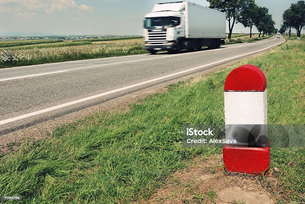 Road milestone with moving truck in the background  Blank Stock Photo