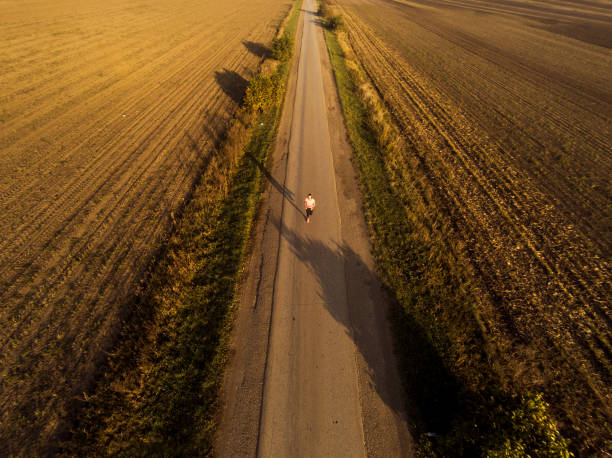 istock Athletic woman running on a road during sunset. 915652980