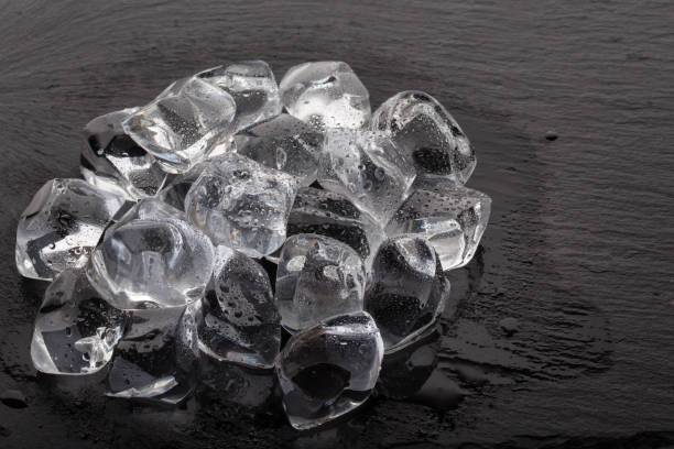 istock A pile of ice cubes on black slate board 915655592