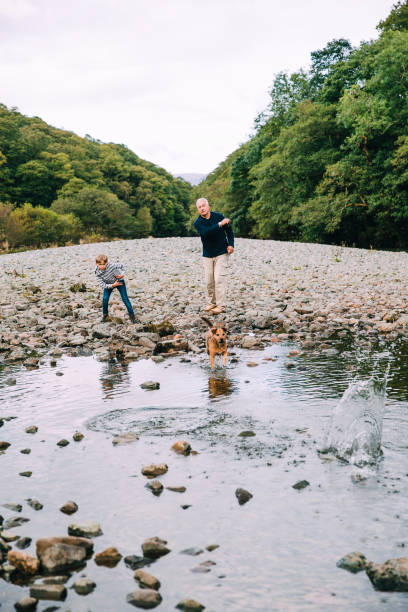 istock Skimming Stones with Grandad 915656352