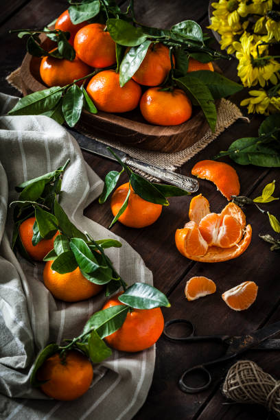 istock Fresh organic mandarins on rustic wooden table 915657248