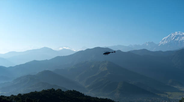 istock Helicopter flying among mountains, Pokhara, Nepal. 915657324