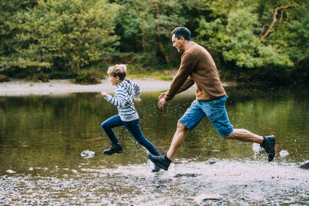 istock Being Chased in to the Water by Dad 915657986