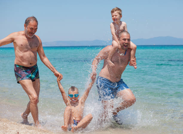 istock Generations Son Father Grandfather Sea Beach Vacation 915660784