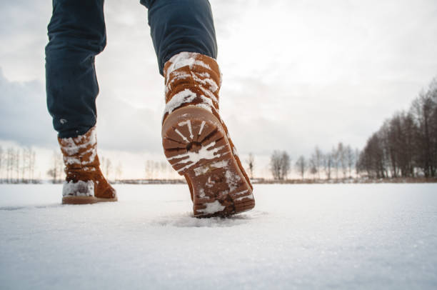 istock Man walks in the snow, rear view, 915661084