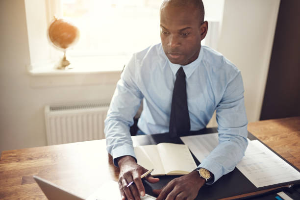 istock Young executive working on a laptop in an office 915664572