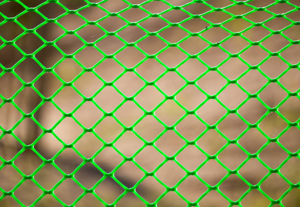 istock Green grid on the fence as a background 915664680