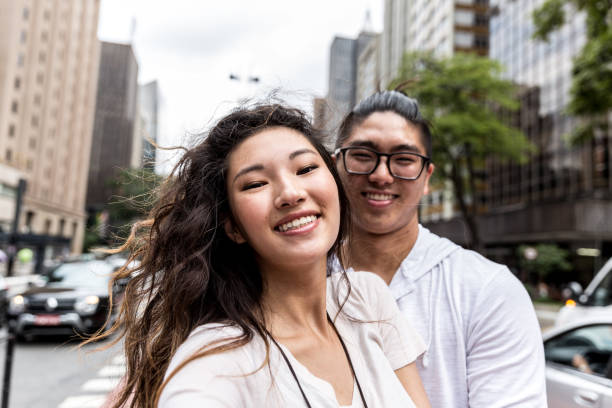 istock Young Asian Couple Taking Selfie 915667506