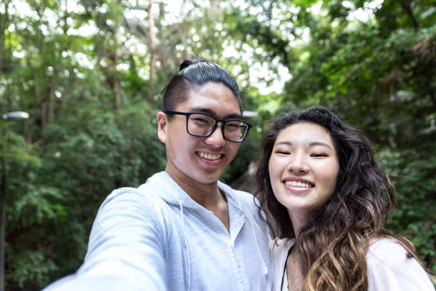 istock Young Asian Couple Taking Selfie 915668942