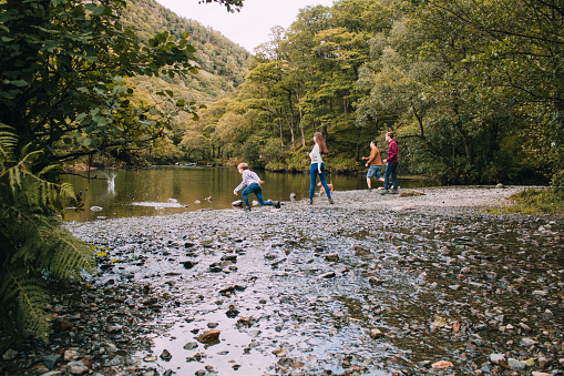 Family Skimming Stones at the Lake District