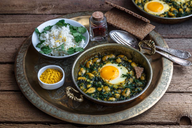 Iranian breakfast made with eggs, bean and dill stock photo