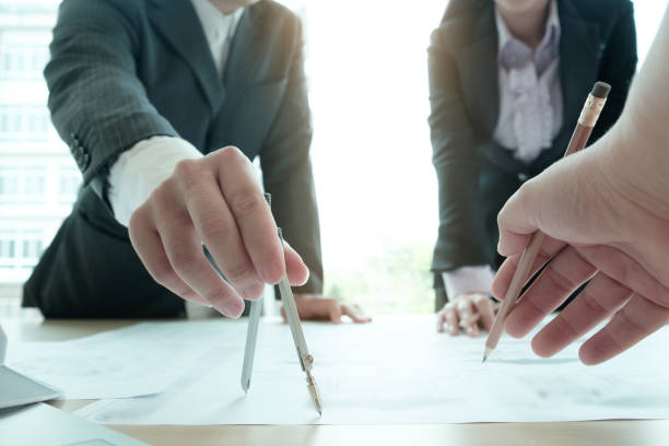 istock architecture team working on blue print with consulting meeting concept. 915669992