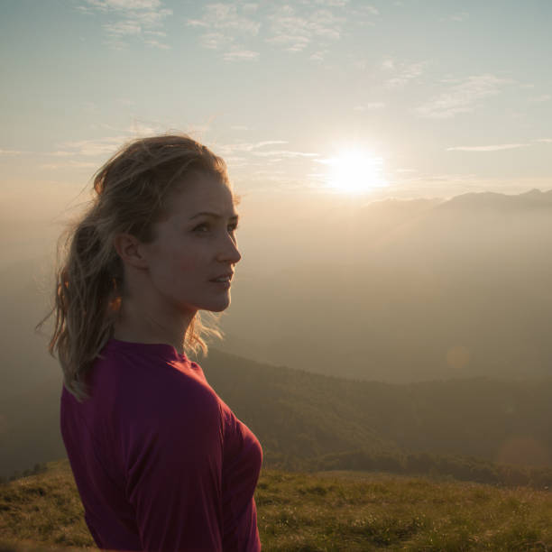 istock Woamn stands on a peak of mountain at sunset 915670502