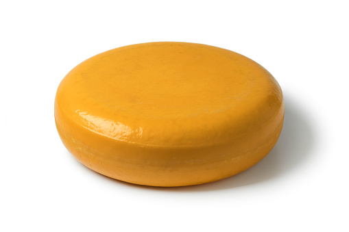 Whole round yellow Gouda cheese isolated on white background