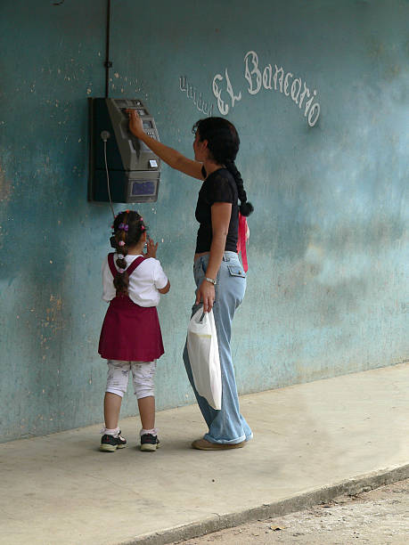 Little girl talking on a public payphone in Vinales Cuba  pay phone on the phone latin american and hispanic ethnicity talking stock pictures, royalty-free photos & images