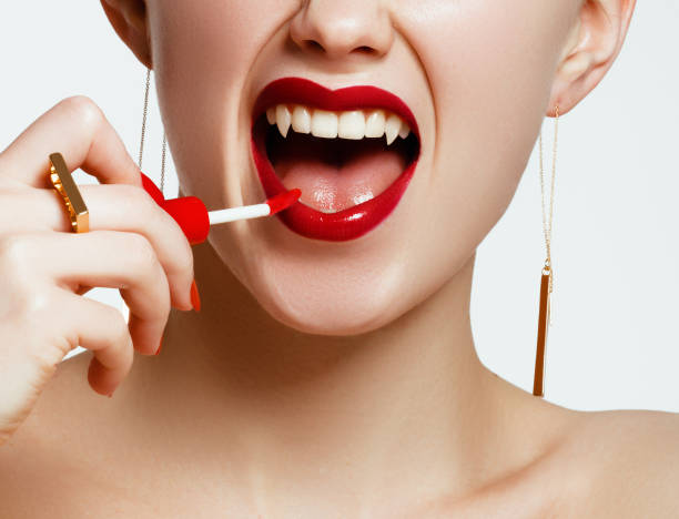 Sexy Woman lips with bloody lipstick. Fashion Glamour Halloween art design. Vampire girl getting ready to celebrate Halloween Sexy Woman lips with bloody lipstick. Fashion Glamour Halloween art design. Vampire girl getting ready to celebrate Halloween vampire woman stock pictures, royalty-free photos & images