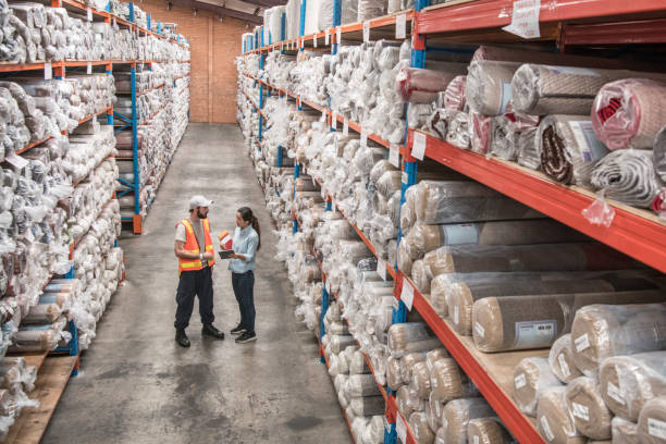 istock Two workers talking in carpet factory high angle view 915681232