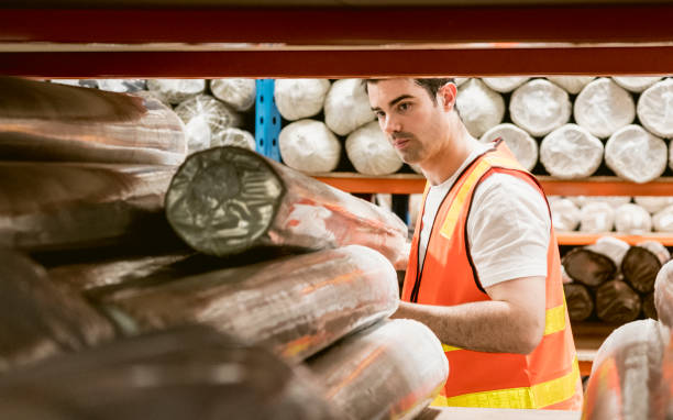 istock Mid adult man working in carpet warehouse 915681278