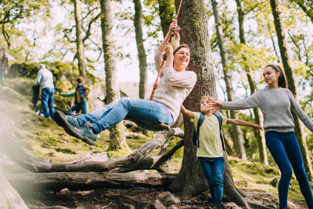 istock Pushing Mum on the Rope Swing 915682224