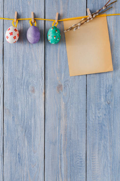 istock Colorful easter card and garland on wood background 915682494