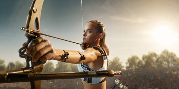 istock Female archer shooting with the longbow at sunset 915688164