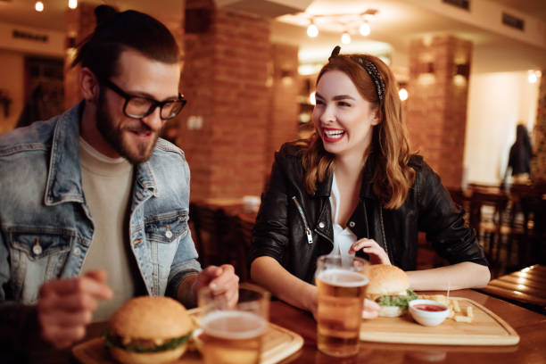 istock Happy couple smiling over a joke while on date 915688384