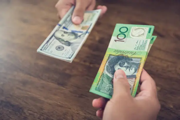 Exchanging money between US dollar (USD) and Australian dollar (AUD) banknotes