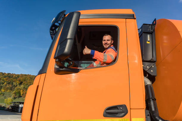 Waste collector driving stock photo
