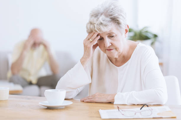 Sad senior woman after quarrel Sad senior woman sitting at table after a quarrel with her husband senior adult memory loss stock pictures, royalty-free photos & images