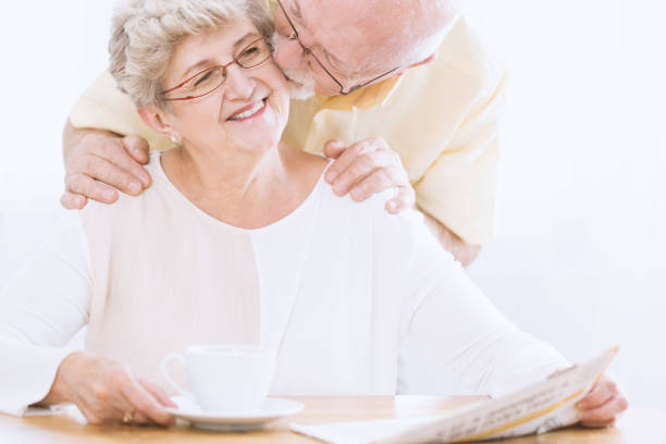 istock Husband kissing elderly woman's cheek 915695484