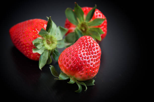 istock Fresh strawberries on black background 915696252