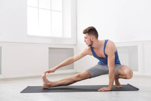 istock Man stretching at white background indoors 915700240