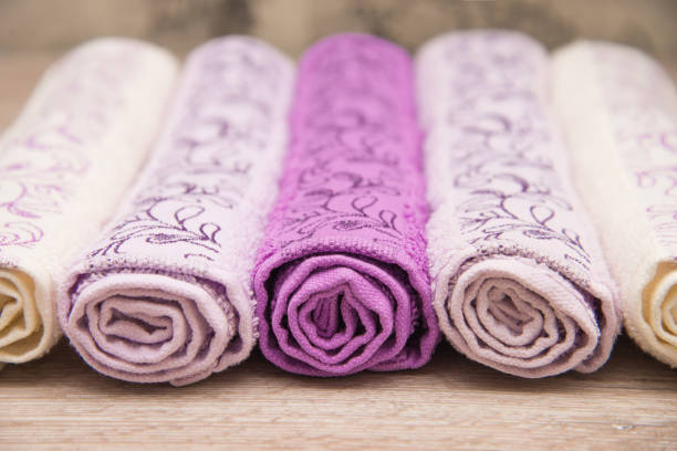 istock Multicolored towels on a wooden background 915700622