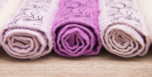 istock Multicolored towels on a wooden background 915700644