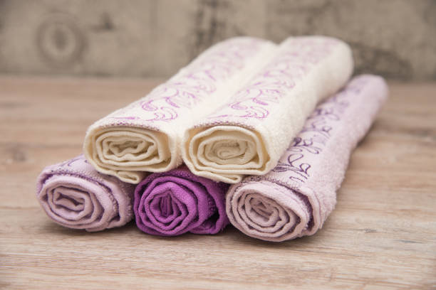 istock Multicolored towels on a wooden background 915700688