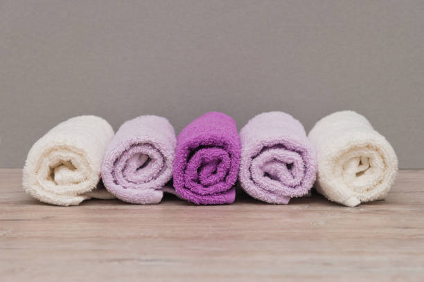 istock Multicolored towels on a wooden background 915700950